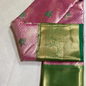 Pink semi silk tissue saree with green flower motif body and   green border and green pallu  Saree with unstitched Blouse material.