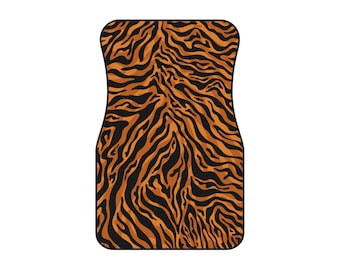 May include: A car floor mat with a tiger stripe pattern in shades of orange and black. The mat has a rectangular shape with rounded corners and is designed to fit the floor of a vehicle.