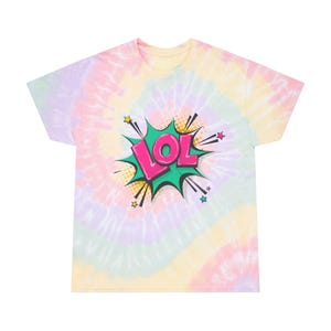 May include: A tie-dye t-shirt with a comic book style "LOL" graphic. The shirt has a swirl pattern in pastel colours including pink, yellow, and purple. The graphic is in a green burst with pink text and star accents.