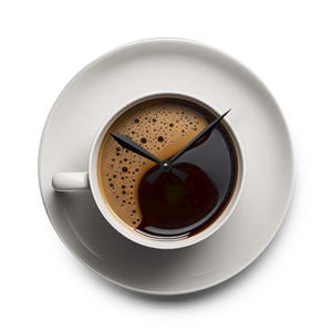 May include: A white coffee cup and saucer with a clock design. The coffee is divided into two sections, one light brown and foamy, the other dark brown. Black clock hands indicate the time.