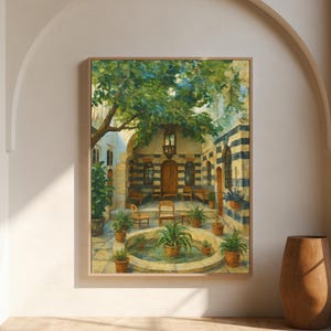 May include: A framed painting depicts a courtyard scene with a fountain, potted plants, and a tree. The artwork features a warm color palette with shades of green, brown, and beige. The painting is displayed in a light-colored room with an arched doorway and a wooden vase.