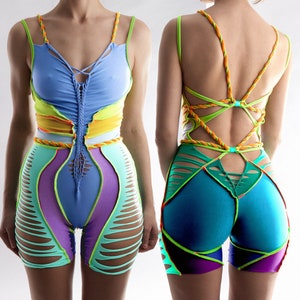 May include: Two pairs of colourful, patterned shorts with a unique design. The shorts are made from a stretchy fabric and have a high-waisted fit. One pair is blue, green and purple with a criss-cross strap design at the back. The other pair is blue, yellow and green with a layered design.