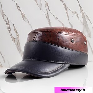 May include: A brown and navy blue leather cap with a flat brim. The top of the cap has a wood grain pattern, and the brim and band are navy blue. The cap has two small silver eyelets on the side.