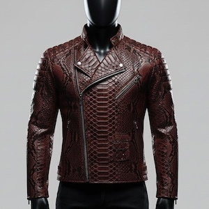 May include: A burgundy leather jacket with a snakeskin pattern. The jacket has a classic biker style with an asymmetrical zip closure, a small pocket, and quilted shoulder detailing. The jacket is displayed on a black mannequin.
