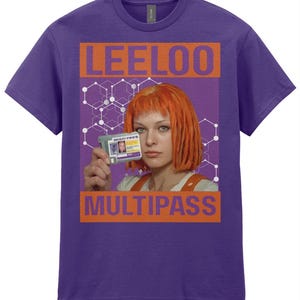 Op de afbeelding: Paars T-shirt met een afbeelding uit de film "The Fifth Element". Het ontwerp bevat de naam "LEELOO" in oranje blokletters boven een afbeelding van het personage dat een "MULTIPASS" ID-kaart vasthoudt. Het woord "MULTIPASS" is in oranje blokletters eronder gedrukt.