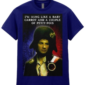 May include: A dark blue short-sleeve t-shirt featuring a graphic print of a historical figure in a military hat. The text above the figure reads, I'M HUNG LIKE A BABY CARROT AND A COUPLE OF PETIT-POIS, set against a red, white, and blue background.