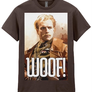 May include: Brown t-shirt featuring a portrait of a man in a military uniform with the word "WOOF!" in large white letters. The portrait shows a man with a mustache and blonde hair.