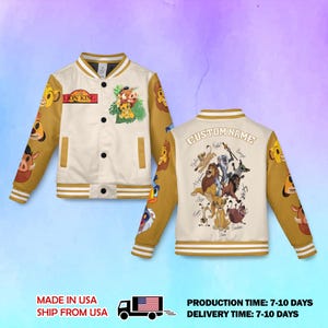 May include: A cream and tan varsity jacket featuring The Lion King logo and character graphics. The front displays Simba, Timon, and Pumbaa. The back shows a group of characters with the text CUSTOM NAME and individual character names.