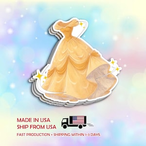 May include: A sticker featuring a yellow ball gown with a layered skirt and off-the-shoulder neckline. The sticker has a white border and is set against a pastel background with stars. Text at the bottom reads "MADE IN USA" and "SHIP FROM USA".