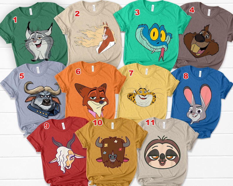 May include: A collection of eleven short-sleeved t-shirts in various colors, each featuring a cartoon animal graphic. The shirts are in shades of green, tan, blue, orange, and yellow, with designs including a snake, a rabbit, and a sloth.