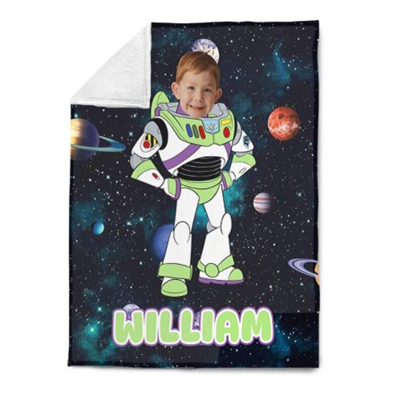 May include: A personalized blanket featuring a child's face integrated into a Buzz Lightyear design, set against a space-themed background with planets and stars. The name "WILLIAM" is displayed in green and white text at the bottom.