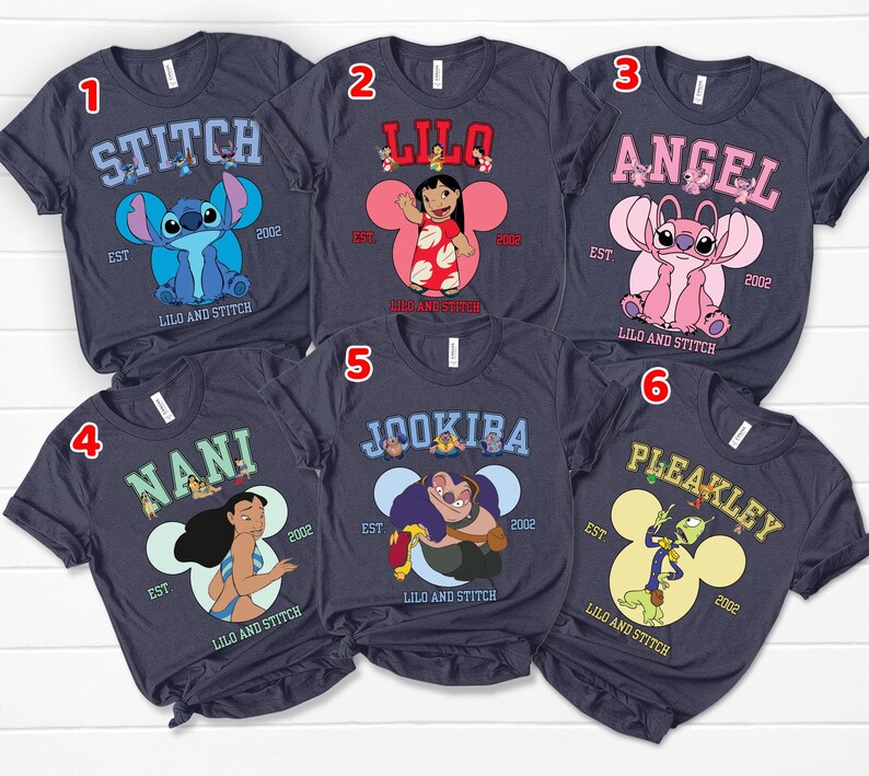 May include: Six navy blue t-shirts featuring characters from the animated film "Lilo & Stitch." Each shirt displays a different character's name in a collegiate font, along with the year "2002" and the phrase "Lilo and Stitch."
