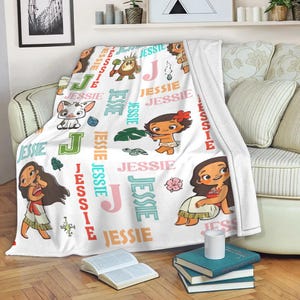 May include: White fleece blanket with cartoon characters and the name "Jessie" in multiple colours. The blanket features a repeating pattern of the name and character illustrations.