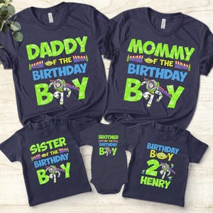 May include: Navy blue t-shirts with green and blue text. The shirts read "Daddy of the Birthday Boy", "Mommy of the Birthday Boy", "Sister of the Birthday Boy", "Brother of the Birthday Boy", and "Birthday Boy 2 Henry".