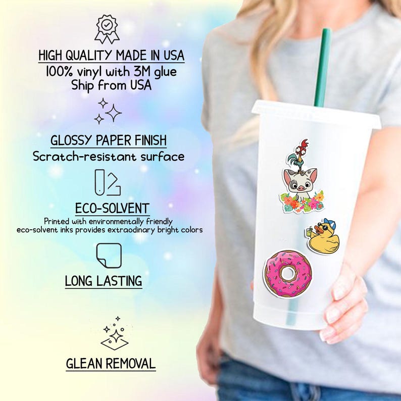 May include: A clear plastic tumbler with a green straw, decorated with colorful cartoon stickers. The stickers include a pig, a rooster, a duck, and a pink donut. The tumbler is held by a person.