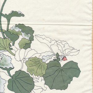 May include: Off-white fabric with a botanical design featuring green and white leaves and stems. A small pink flower is visible. The signature "Jim Thompson" is in the bottom right corner. The design is reminiscent of a vintage textile.