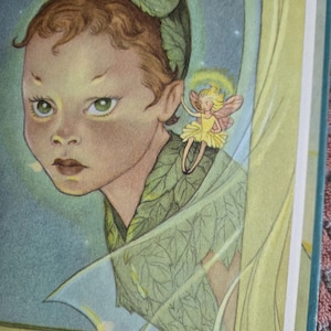 May include: Illustration of a young person with green eyes and brown hair, adorned with leaf accents. A small fairy with yellow wings and a yellow dress hovers nearby. The artwork has a soft, vintage aesthetic with a whimsical theme.