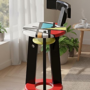 May include: A modern, black and red bar stool with a geometric design on the seat. The seat features a colorful abstract pattern with yellow, blue, and red accents. The stool has a red footrest and a black backrest.