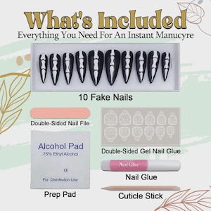 May include: A set of 10 black press-on nails with white skeleton finger bone designs, a double-sided nail file, an alcohol prep pad, a sheet of double-sided gel nail glue, a tube of nail glue, and a wooden cuticle stick for a manicure.