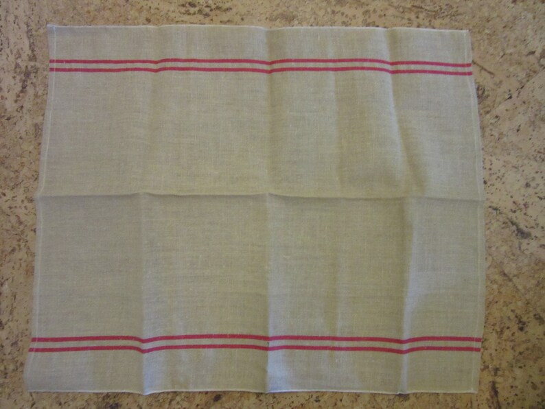 May include: A plain white tea towel with two red stripes along the top and bottom edges.