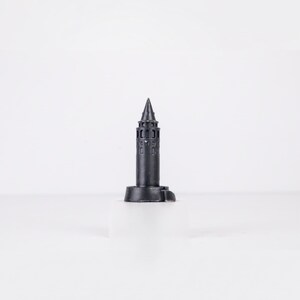 Black finish Galata Tower miniature with arched windows and a conical roof on a white background