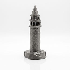 Raw finish Galata Tower miniature in unpolished cast stainless steel, front view with arched windows and stone texture on a white background