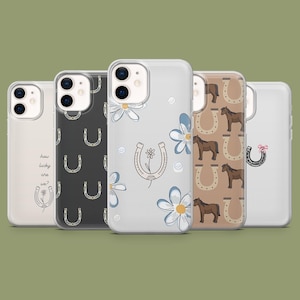 May include: Five clear phone cases with various designs. One case has the text "how lucky are we?" with a horseshoe and flower. Other cases feature horseshoes, horses, and flowers in different colors.