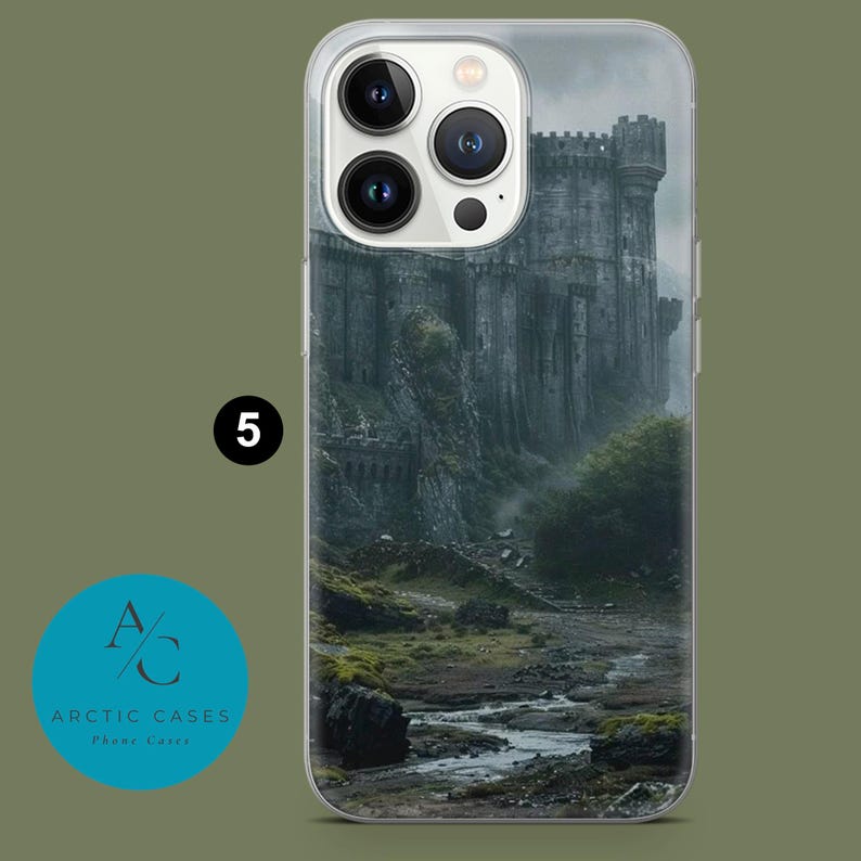 May include: Clear phone case featuring a detailed illustration of a medieval castle on a rocky landscape. The castle is gray with a cloudy sky background. The phone case has a clear border and the number 5 is visible.