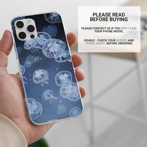 May include: A clear phone case with a blue background and a pattern of white jellyfish. The case is designed for an iPhone 13 Pro Max.