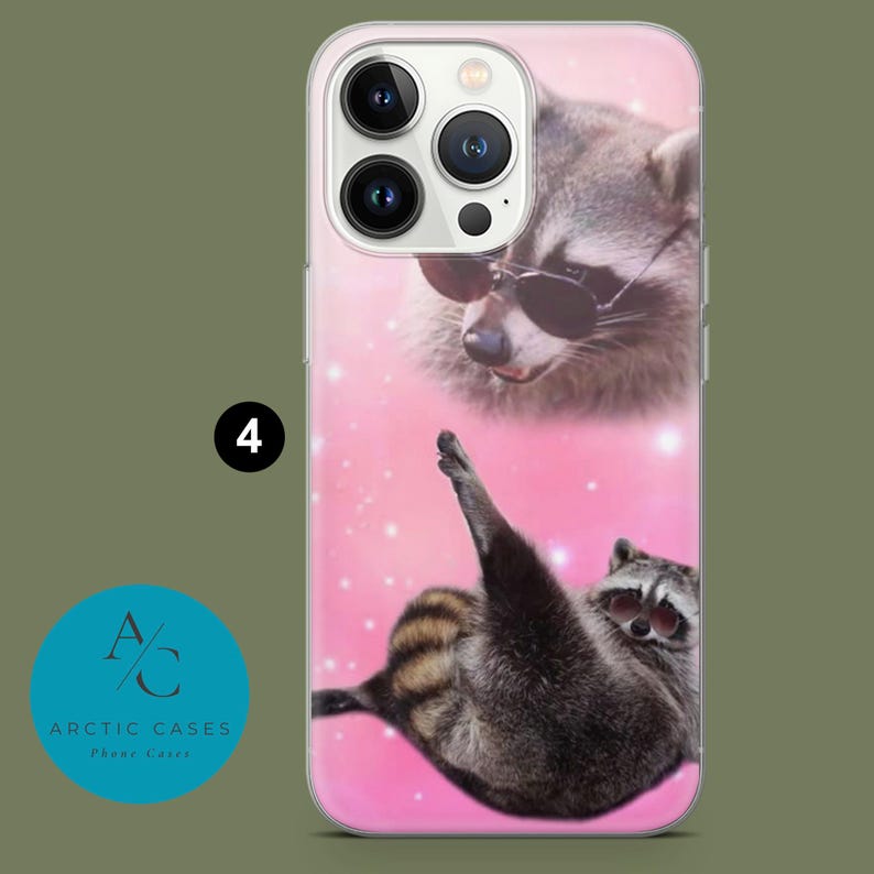 May include: A clear phone case with a pink background and two raccoons wearing sunglasses. The top raccoon is looking down at the bottom raccoon, who is lying on its back with its paws in the air.