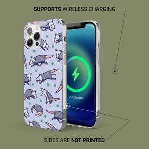 May include: A clear phone case with a colorful design of possums and leaves on a light blue background. The case is shown on a phone with a wireless charging animation on the screen. The text "SUPPORTS WIRELESS CHARGING" is at the top of the image and the text "SIDES ARE NOT PRINTED" is at the bottom of the image.
