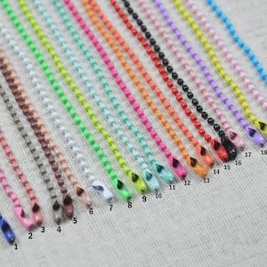May include: A collection of colorful ball chains in various shades, including blue, pink, brown, green, and orange. Each chain has a matching colored end piece. The chains are numbered from 1 to 21.