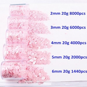 May include: Five clear jars filled with pink sequins of varying sizes. The jars are labeled with the size, weight, and quantity of the sequins: 2mm 20g 8000pcs, 3mm 20g 6000pcs, 4mm 20g 4000pcs, 5mm 20g 2000pcs, and 6mm 20g 1440pcs.
