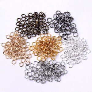 May include: Assortment of jump rings in gold, silver, and bronze colors. The jump rings are small and perfect for jewelry making.