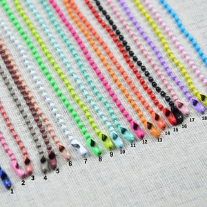 May include: Twenty-one colorful metal chains with a loop at the end. The chains are numbered 1 through 21.