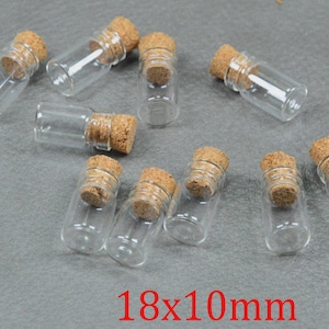 May include: A selection of small, clear glass bottles, each sealed with a cork stopper. The bottles are cylindrical and transparent. The image includes the text "18x10mm" in red, indicating the size of the bottles (approximately 1.8 x 1.0 cm).