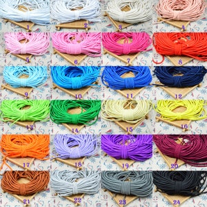 May include: Twenty-four spools of colorful elastic cord, each wound into a circle. The colors include white, pink, light blue, red, blue, navy, green, yellow, orange, purple, maroon, brown, gray, and black.