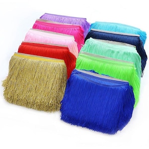 May include: A selection of vibrant fringe trim in a range of colours, such as gold, red, pink, purple, blue, and green. The trim is densely packed and appears to be made of a shiny material. Suitable for crafting and embellishments.