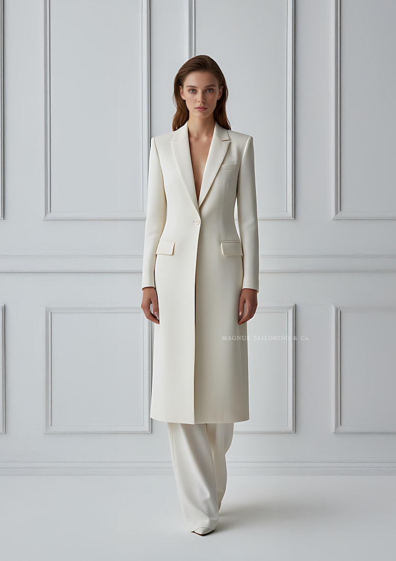 Side angle showing structured tailoring of ivory blazer coat