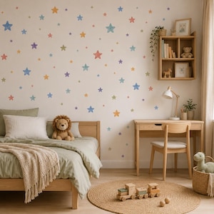 May include: A wall decorated with numerous small, multi-colored star decals in shades of blue, yellow, orange, green, and purple. The room features a wooden bed with sage green bedding, a wooden desk with a chair, and a wooden shelf with decor.