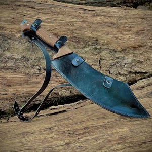 High-performance hand-forged machete blade made from 1095 carbon steel. This large knife is built for durability, precision, and strength, making it a great survival knife or camping companion. Ideal gift for outdoorsmen, hunters, and those who appreciate handmade quality knives.