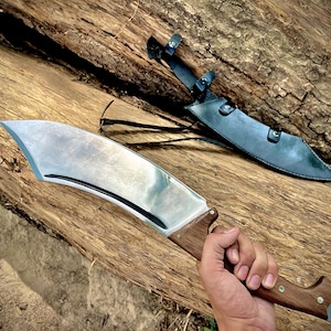 A rugged outdoor machete knife made with high-carbon steel and designed for adventure. Perfect as a birthday gift for dad or an outdoor enthusiast, this handmade blade combines traditional style with reliable performance. Durable, beautiful, and functional for heavy use in the field.