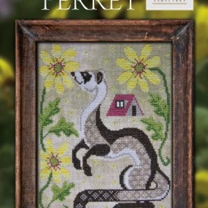 May include: A cross-stitch pattern featuring a ferret standing on its hind legs with a small house in the background. The ferret is surrounded by yellow flowers with green leaves. The title "The Ferret" is above the image and "A Year in the Woods #5" is above the title. The image is framed in a brown wooden frame.