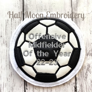 May include: White and black soccer ball patch with white embroidery that reads "Offensive Midfielder Of the Year 22-23".