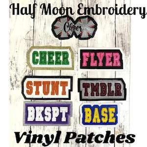 May include: A collection of embroidered vinyl patches featuring the text Half Moon Embroidery and Vinyl Patches. The patches display words including Cheer, Flyer, Stunt, Tmblr, Bkspt, and Base in various colors like green, pink, orange, and yellow.