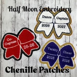 May include: Three bow-shaped chenille patches with gold glitter borders. One red patch reads Co-Captain 25-26, one white patch reads Dance Captain 2026 2027, and one purple patch reads Varsity Cheer 2025 2026. Text reads Half Moon Embroidery Chenille Patches.