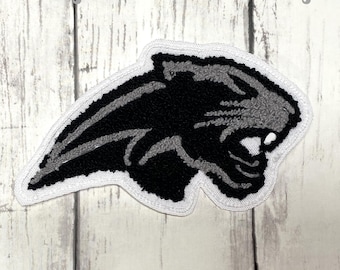May include: A black and gray chenille patch in the shape of a panther's head with a white border. The text "Half Moon Embroidery" is at the top, and "Chenille Patches" is at the bottom.