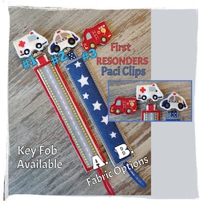 May include: Three fabric pacifier clips with embroidered images of a police car, ambulance, and fire truck. The clips are labeled #1, #2, and #3. The fabric options are labeled A and B. The text "First Responders Paci Clips" is also included.