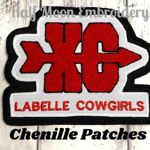 May include: Red and white chenille patch with the text "XC" and "Labelle Cowgirls".