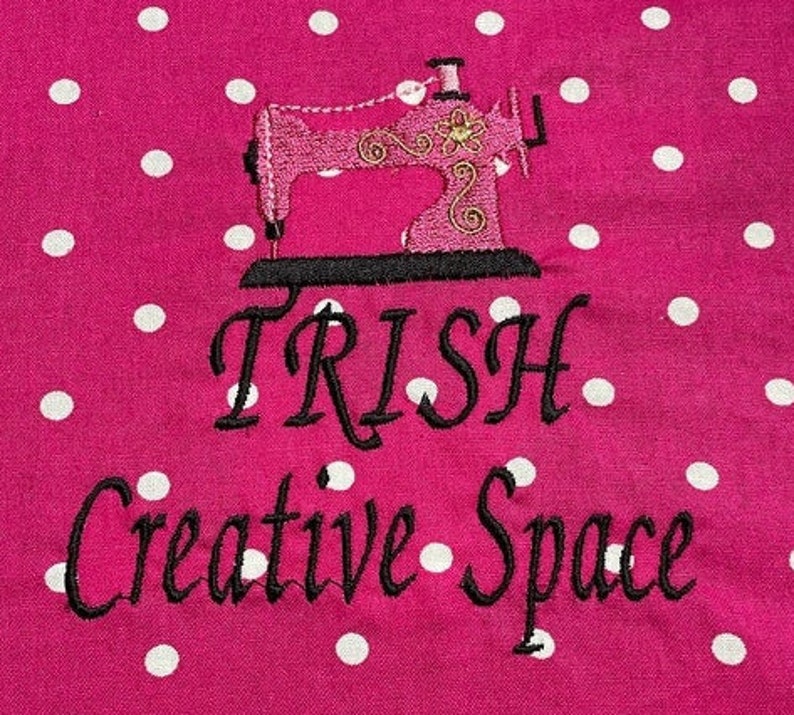 May include: Pink sewing machine with gold accents on a pink background with white polka dots. The text "TRISH Creative Space" is below the sewing machine.